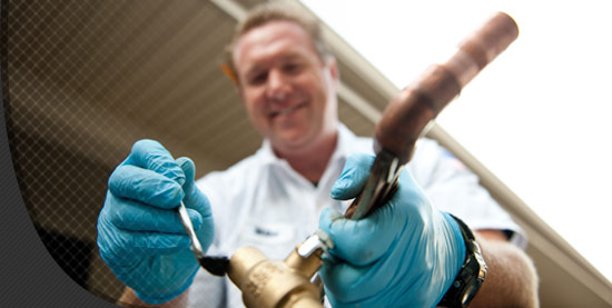 Plumber checking a outdoor pipe