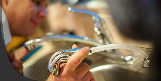 Syracuse plumber checking a ktichen sink waterline